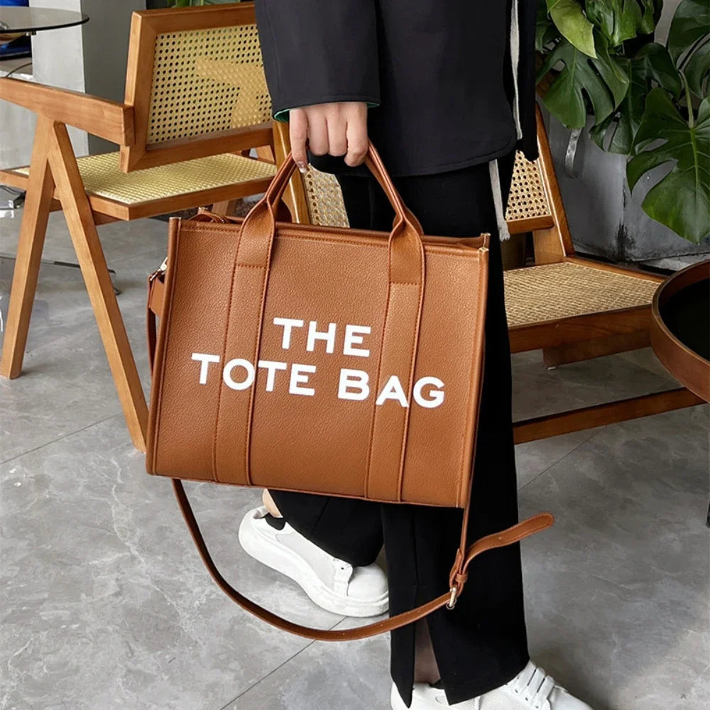 Upgrade your style with this chic solid color leather tote bag! Perfect for all your outdoor leisure activities. #Fashion #ToteBag #LeatherBag